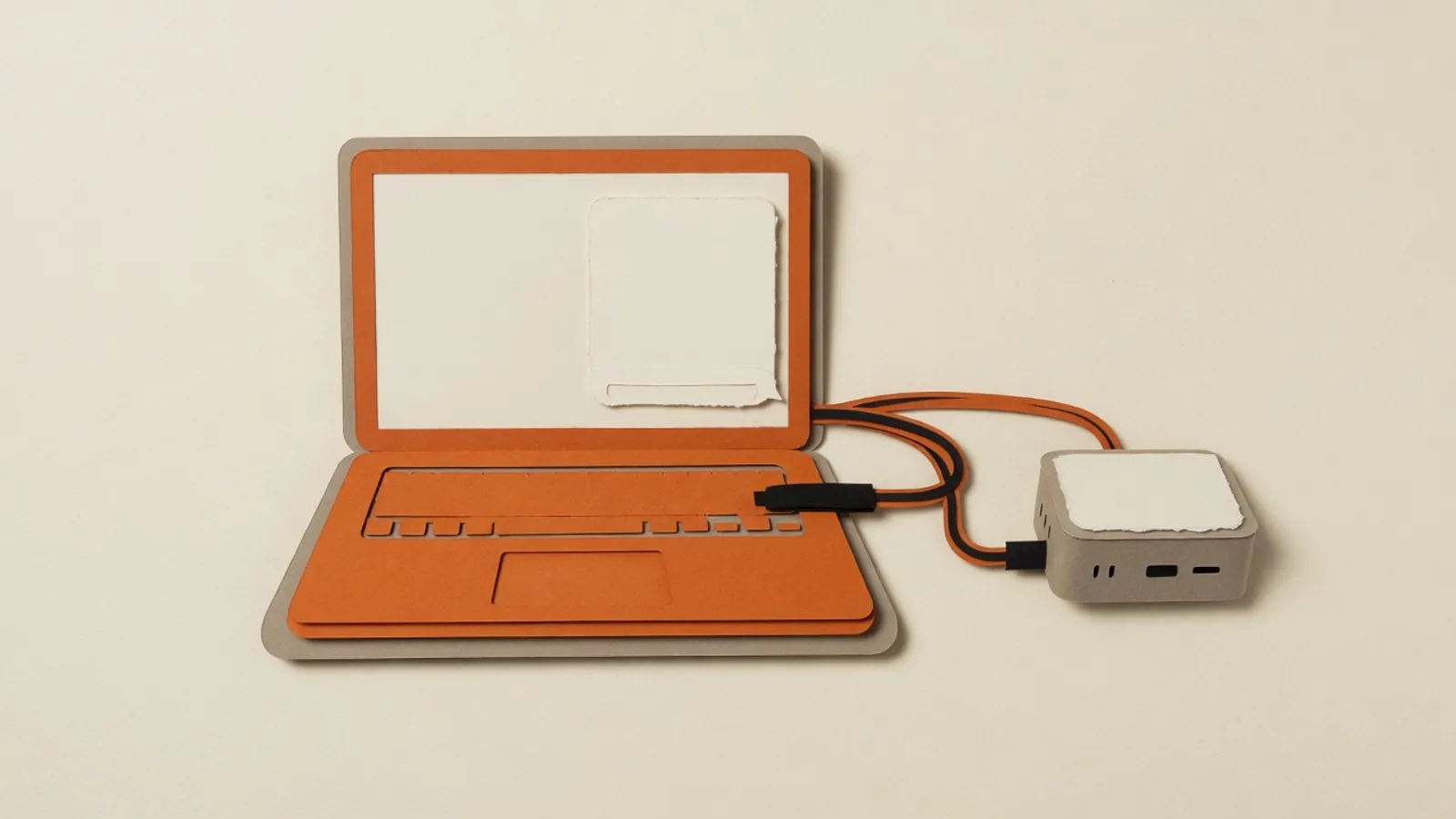 Cut-paper laptop cabled to a blank chat window, with a small compact computer beside it.